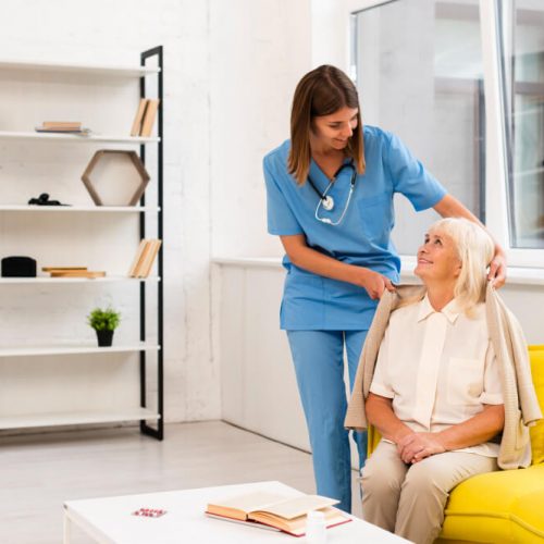 long-shot-nurse-helping-old-woman-with-her-coat